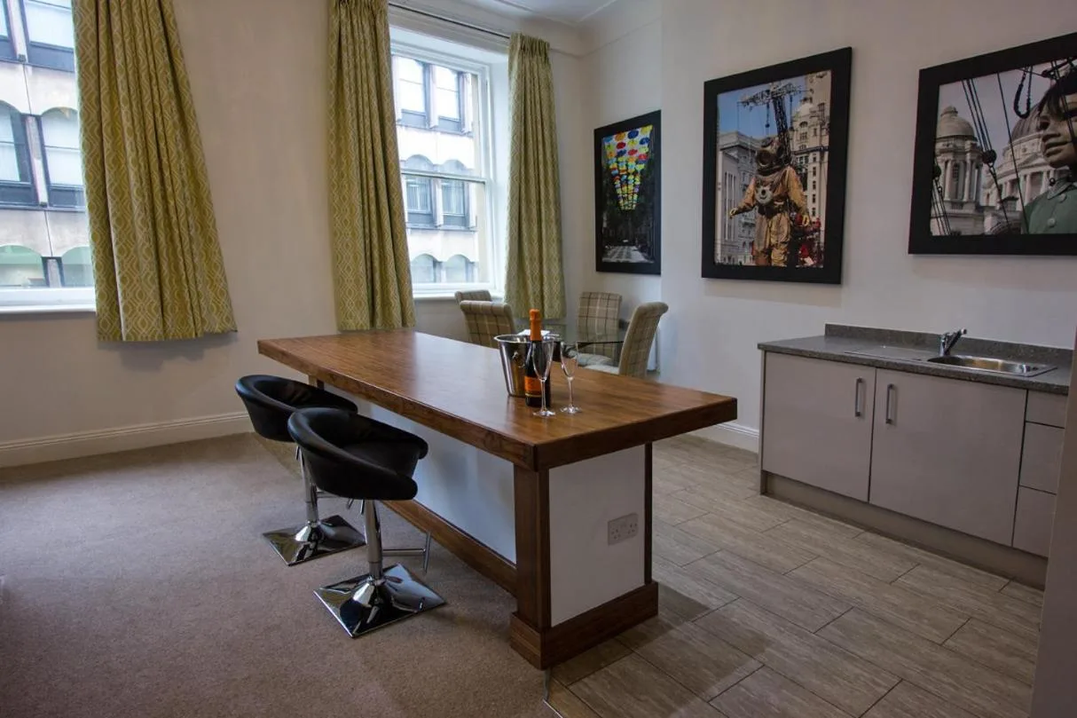 a kitchen with a table and chairs in a room at The Castle Collection 14 Cook Street in Liverpool