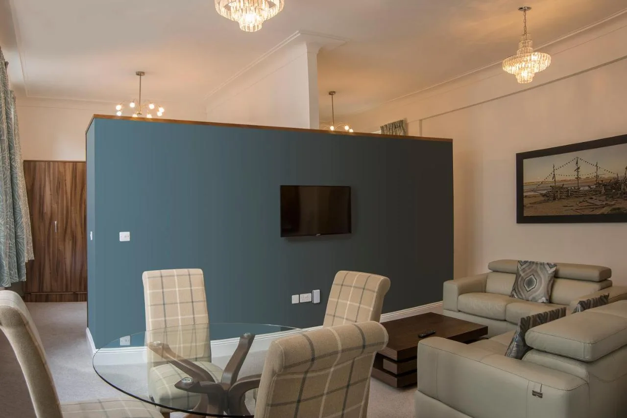 a living room with a glass table and chairs at The Castle Collection 14 Cook Street in Liverpool